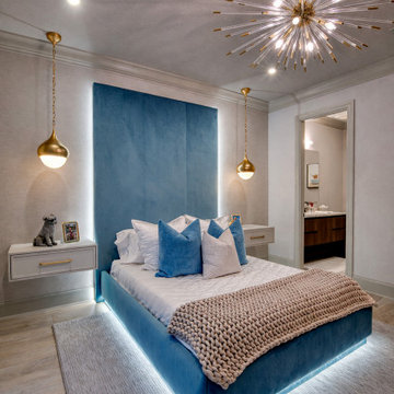 Blue Bedroom with Backlit Headboard and Statement Chandelier