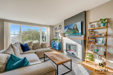 Inspiration for a mid-sized living room remodel in San Diego with gray walls, a tile fireplace and a wall-mounted tv