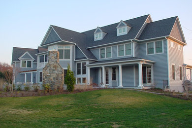 Inspiration for a large timeless gray two-story concrete fiberboard exterior home remodel in Baltimore with a shingle roof