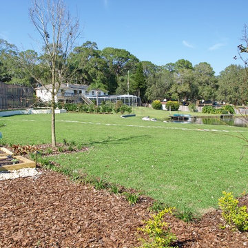 Tudor Revival backyard lakefront landscape design