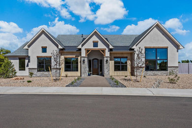 Inspiration for a large transitional gray one-story stucco exterior home remodel in Other with a mixed material roof and a gray roof