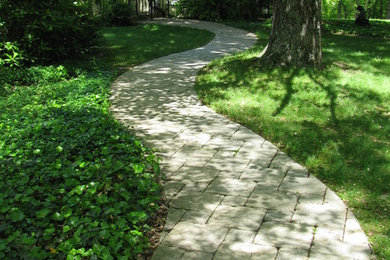 Design ideas for a full sun front yard brick garden path in Other.