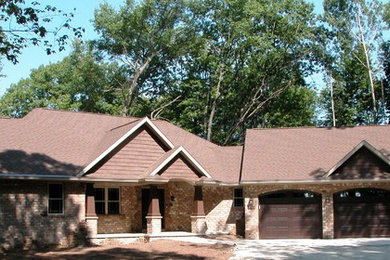 Inspiration for a mid-sized one-story brick exterior home remodel in Other