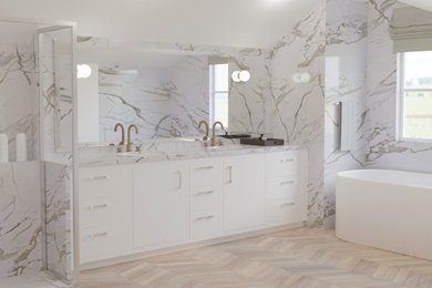 This is an example of a large modern ensuite bathroom in Essex with flat-panel cabinets, white cabinets, a freestanding bath, a walk-in shower, white tiles, marble tiles, beige walls, wood-effect flooring, a submerged sink, marble worktops, brown floors, an open shower, white worktops, a wall niche, double sinks and a built in vanity unit.