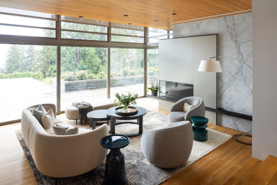 Huge trendy open concept medium tone wood floor and orange floor family room photo in Vancouver with a two-sided fireplace, a concrete fireplace and no tv