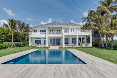 Large beach style rectangular pool in Miami with tile.