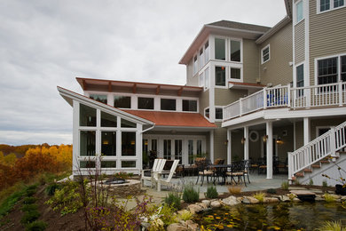 Inspiration for a huge coastal beige three-story concrete fiberboard exterior home remodel in Boston with a clipped gable roof