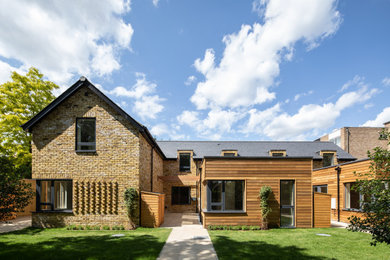 This is an example of a medium sized rustic two floor brick and rear detached house in London.