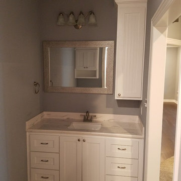 Cultured marble vanity tops in both baths with under mount sinks.