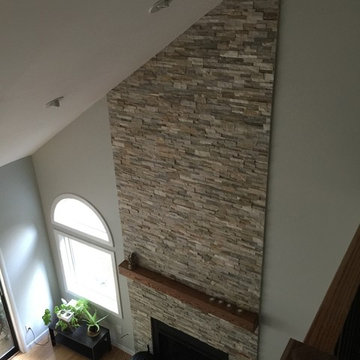 Ben's stacked stone fireplace with reclaimed wood mantle