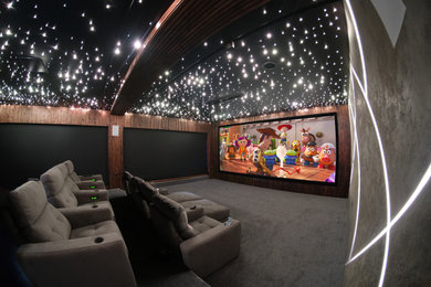 Inspiration for an expansive modern enclosed home cinema in Cheshire with grey walls, carpet, a projector screen and grey floors.