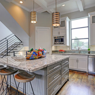 Große Klassische Küche in U-Form mit Vorratsschrank, Unterbauwaschbecken, Lamellenschränken, weißen Schränken, Laminat-Arbeitsplatte, Küchenrückwand in Weiß, Rückwand aus Keramikfliesen, Küchengeräten aus Edelstahl, dunklem Holzboden und Kücheninsel in Houston