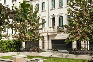 Example of a large transitional white three-story concrete townhouse exterior design in Houston