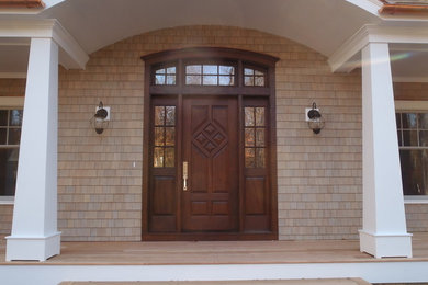 Example of a large classic brown two-story wood house exterior design in New York