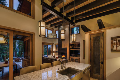 Inspiration for a craftsman open concept kitchen remodel in Seattle with a farmhouse sink, terrazzo countertops and an island