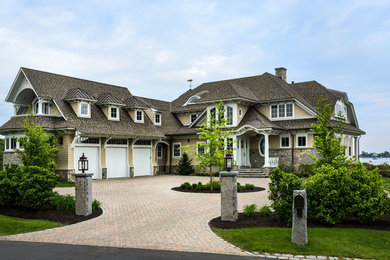Huge beach style beige two-story mixed siding exterior home photo in Boston with a hip roof and a shingle roof