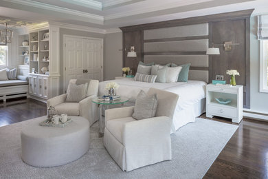 Huge transitional master medium tone wood floor and brown floor bedroom photo in New York with gray walls, a standard fireplace and a tile fireplace
