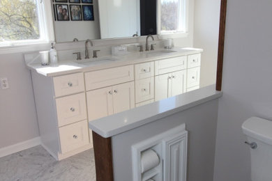 Mid-sized transitional master gray tile and ceramic tile ceramic tile, gray floor and double-sink bathroom photo in Baltimore with shaker cabinets, white cabinets, a two-piece toilet, gray walls, a drop-in sink, marble countertops, a hinged shower door, white countertops and a built-in vanity
