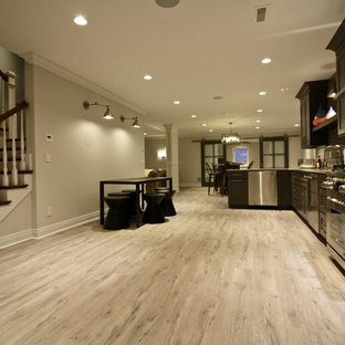 This is an example of a large classic look-out basement in St Louis with grey walls, vinyl flooring and grey floors.
