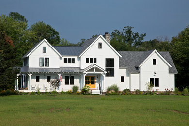 Country two-storey white exterior in Boston with wood siding.
