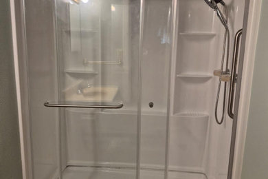 Mid-sized elegant white tile vinyl floor, brown floor and single-sink bathroom photo in Indianapolis with a one-piece toilet, green walls, granite countertops and yellow countertops