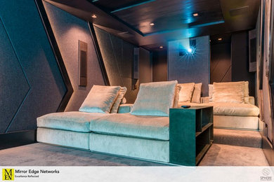Home theater - small contemporary enclosed carpeted and gray floor home theater idea in Other with black walls and a projector screen