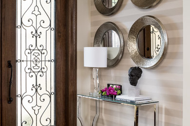 Mid-sized transitional light wood floor and beige floor entryway photo in Miami with beige walls and a dark wood front door