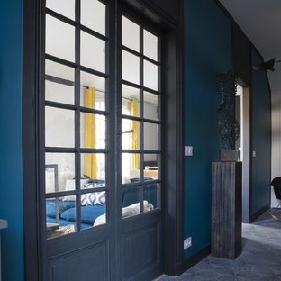 Design ideas for a large eclectic foyer in Paris with concrete floors, grey floor and grey walls.