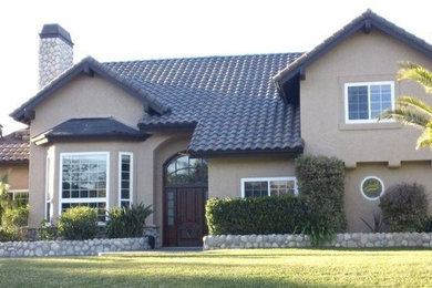 Inspiration for a beige two-story exterior home remodel in San Diego
