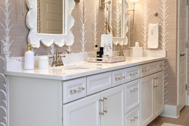 Bathroom - mid-sized coastal master white tile and subway tile ceramic tile, beige floor, double-sink, coffered ceiling and wallpaper bathroom idea in Charleston with recessed-panel cabinets, white cabinets, a two-piece toilet, beige walls, an undermount sink, marble countertops, a hinged shower door, white countertops and a built-in vanity