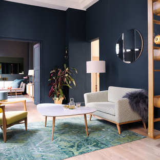 Modern inredning av ett vardagsrum, med ett finrum, ljust trägolv och blå väggar