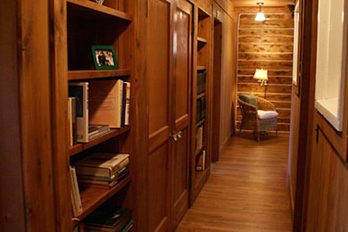 Small medium tone wood floor hallway photo in Other