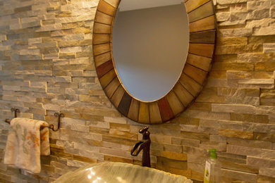 Bathroom - mid-sized cottage 3/4 stone tile and beige tile ceramic tile bathroom idea in Other with beige walls, solid surface countertops, a vessel sink, louvered cabinets and dark wood cabinets