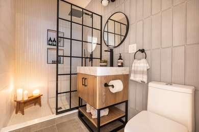 Inspiration for a mid-sized modern 3/4 white tile and porcelain tile porcelain tile, gray floor and single-sink bathroom remodel in Chicago with flat-panel cabinets, light wood cabinets, a one-piece toilet, beige walls, an undermount sink, quartzite countertops, white countertops and a freestanding vanity