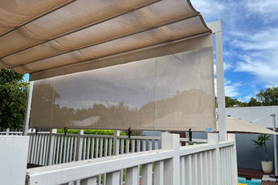 Mid-sized traditional backyard screened-in verandah in Perth with decking, an awning and wood railing.