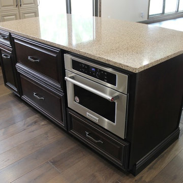 Farmhouse kitchen Taupe Painted Cabinets,Quartz Tops, and Dark Island