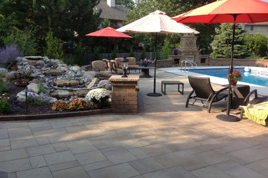 Large mediterranean backyard partial sun garden in Chicago with brick pavers for summer.
