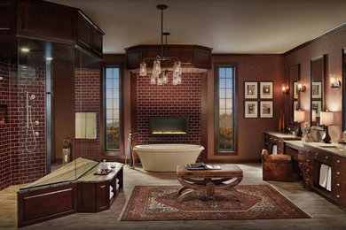 Photo of a large traditional master bathroom in New Orleans with beaded inset cabinets, dark wood cabinets, a freestanding tub, red tile, subway tile, red walls, dark hardwood floors, an undermount sink, granite benchtops, brown floor and a hinged shower door.