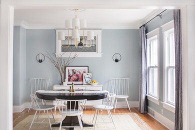 Transitional separate dining room in Chicago with grey walls, medium hardwood floors and brown floor.