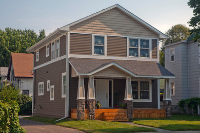 Mid-sized modern brown two-story vinyl exterior home idea in Minneapolis with a shingle roof