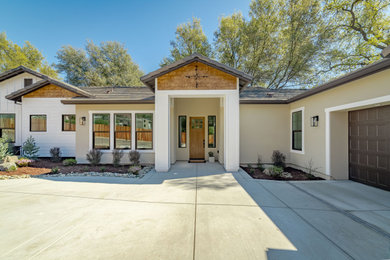 Photo of a mid-sized transitional one-storey multi-coloured house exterior in Sacramento with concrete fiberboard siding, a gable roof and a tile roof.