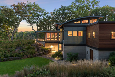 This is an example of an expansive modern two-storey exterior in Minneapolis with mixed siding.