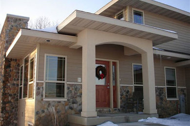 Example of a mid-sized classic beige two-story exterior home design in Other