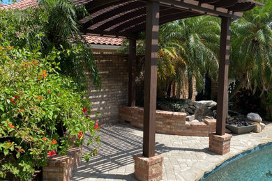 Inspiration for a mid-sized contemporary backyard brick pool remodel in Other