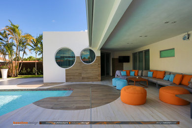 Inspiration for a mid-sized contemporary tile screened-in back porch remodel in Miami with a roof extension