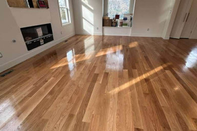 Large elegant enclosed medium tone wood floor, brown floor and coffered ceiling living room photo in Orlando