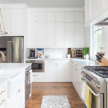 White Kitchen with Farmhouse Sink, Brass Hardware and Pro Range