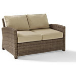 Crosley - Bradenton Outdoor Wicker Loveseat With Sand Cushions - Create the ultimate in outdoor entertaining with Crosley's Bradenton Collection. This elegantly designed all-weather wicker conversational set is the perfect addition to your environment. The finely crafted deep seating collection features intricately woven wicker over durable steel frames, and UV/Fade resistant cushions providing comfort, style and durability.