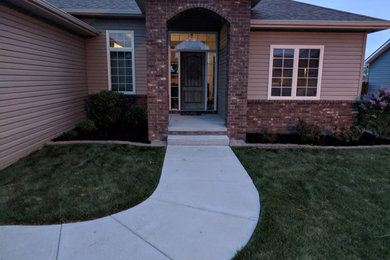 This is an example of a mid-sized partial sun front yard landscaping in Other.
