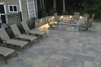 Transitional patio in Providence with a fire feature.